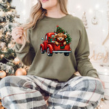 Red Truck Cow DTF Heat Transfer, Christmas sweater with a festive graphic of a cow with horns in the back of a red truck and a decorated Christmas tree