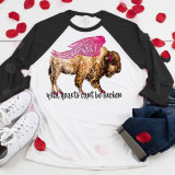 Wild Hearts Rome Free Sublimation Transfer, a T-shirt featuring a leopard with pink wings and the phrase "wild hearts can't be broken" printed underneath, surrounded by white sneakers, jeans, and red rose petals.