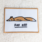 Fox Off Embroidered HAT/POCKET Patch, embroidered patch featuring a lying fox with the text 'FOX OFF' underneath, bordered with a copper-colored edge.