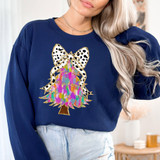 Bright Colorful Christmas Tree Faux Glitter DTF Heat Transfer, close-up of a woman wearing a navy blue sweatshirt with a vibrant, glittery Christmas tree and bow design.