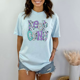 Keep Going DTF Heat Transfer, colorful graphic design with the phrase "Keep Going" on a light blue t-shirt.