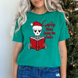 Santa, Please Bring Books DTF Heat Transfer, Christmas-themed graphic T-shirt with a skeleton wearing a Santa hat and holding a book.