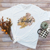 Thankful word art fall colors rose gold leopard pattern sublimation transfer design printed on a white T-shirt.