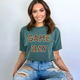 Game Day ADULT Screen Print Transfer, woman wearing a green t-shirt with leopard print 'Game Day' text for sports fans.