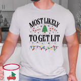 Most Likely To Get Lit Festive DTF Heat Transfer, image of a person wearing a holiday-themed T-shirt with Christmas lights, a decorated Christmas tree, candy canes, and snowflakes, celebrating Christmas.