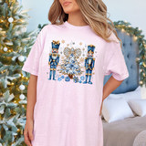 Blue Nutcrackers DTF Heat Transfer, Christmas nutcracker design on pink T-shirt with festive holiday background.