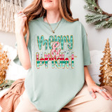 Merry & Bright Patterned DTF Heat Transfer, colorful holiday-themed design on a mint green T-shirt with Christmas decor around.