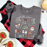 Tis The Season Christmas Favorites WHITE DTF Heat Transfer, illustrated Christmas holiday icons on a gray sweatshirt, including a Christmas tree, Santa, snowmen, gift boxes, cookies, and festive decorations.