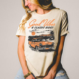 Good Vibes And Classic Rides DTF Heat Transfer, graphic of a vintage car with sunset background on a beige T-shirt.