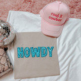 Dark Teal Groovy Faux Sequins Letters DTF Heat Transfer, blue glitter letter patches spelling 'HOWDY' on a beige fabric, with a pink 'Cool it cowboy' trucker hat and a mirrored disco ball in the background.
