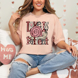 Love Is Patient Snail DTF Heat Transfer, woman wearing a pink T-shirt with a snail design and text, sitting on a cozy couch in a Valentine's Day themed room.