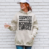 Suspect Claims She Is Running Errands But Is Out Shopping At Target DTF Heat Transfer, a woman with red hair, wearing a beige hoodie with bold black text, holding a glass of rosé wine, standing in front of a white brick wall.