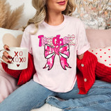 Teacher Valentine Coquette DTF Heat Transfer, pink T-shirt with a graphic of a pink bow and the word 'Teacher' in pink letters.