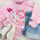 Disco Ball Heart Sequin Patch, pink sequin heart-shaped patch with iridescent reflective surface on a pink sweatshirt.