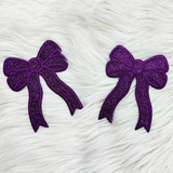 Purple Glitter Bow Sides Sequin Patch SET OF 2, decorative purple bow patches with glitter and stitched edges on a white furry background.