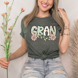 Gran Easter Pattern DTF Heat Transfer, colorful floral design with the word 'GRAN' in large, decorated letters on a woman's T-shirt.