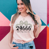 Ninety Six, SC Zip Code Bow DTF Heat Transfer, customized t-shirt design with number 29666 and text Ninety Six, SC, worn by a smiling woman against a colorful mural background.
