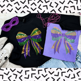 Mardi Gras Bow Spangle Heat Transfer, colorful glitter bow design on black and purple shirts, with accessories like purple mask and white sneakers.