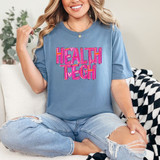 Painted Health Tech DTF Heat Transfer, woman wearing blue T-shirt with vibrant pink and purple heat transfer design reading 'HEALTH TECH'.