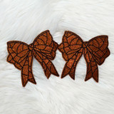 Basketball Bow Sides Glitter Patch SET OF 2, orange glittery basketball bow patches with black outlining on a white furry background.