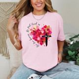 We Love Because He First Loved Us DTF Heat Transfer, pink t-shirt with a heart and cross design with biblical quote and colorful hearts.