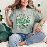 Not Lucky Simply Blessed Coquette Shamrock DTF Heat Transfer, a woman wearing a light green T-shirt with a shamrock design and positive quote, sitting on a beige couch with green pillow, celebrating St. Patrick's Day.