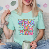 Some Bunnies Favorite Momma DTF Heat Transfer, colorful Easter-themed bunny design on a light green t-shirt.