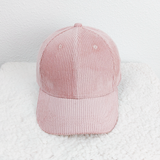 Soft Pink Corduroy Hat, a stylish light pink cap made of soft corduroy fabric with a rounded crown and a curved brim.