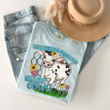 Don't Mind Me, Just Over Here Raising Cows DTF Heat Transfer, a light blue T-shirt with a cow illustration and floral design.