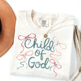 Child Of God Bow DTF Heat Transfer, white T-shirt with biblical quote and colorful ribbon bows design.