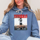 Zimmerman DTF Heat Transfer, customized hoodie with a photo of a person on stage and bold red text overlay.