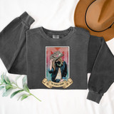 The Buckle Bunny DTF Heat Transfer, a graphic design featuring a woman wearing a hat with a floral decoration and denim jacket, with a banner reading 'The Buckle Bunny' below, applied on a gray sweatshirt.