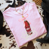 Dr P Coquette Bow DTF Heat Transfer, pink T-shirt with Dr. Pepper bottle design decorated with pearls and a pink bow.