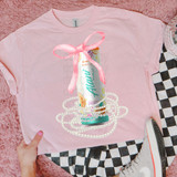 Alani Coquette Bow DTF Heat Transfer, pink t-shirt with a printed energy drink bottle design, pink bow detail, and pearl beads illustration.