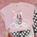 Diet Cola Coquette Bow DTF Heat Transfer, pink T-shirt with a graphic of a soda can decorated with a pink bow, surrounded by pearl necklaces.