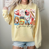 Baseball Game Day Collage DTF Heat Transfer, colorful baseball-themed design on a yellow sweatshirt.