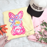 Pink Bunny CLEAR Screen Print Heat Transfer, pink bunny design with a ribbon on yellow fabric.