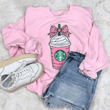 Pink Drink Coquette Sequins Patch, pink sweatshirt with a Starbucks drink design adorned with sequins, paired with denim shorts and white sneakers.