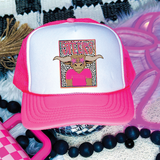 Steers Colorful Mascot DTF Heat Transfer, a pink and white trucker hat with a badge featuring a cartoon steer wearing star-shaped sunglasses and a pink shirt, surrounded by decorative elements.