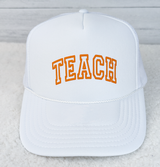 TEACH Orange PUFF Hat/Pocket Screen Print Heat Transfer, white trucker-style cap with orange embroidered TEACH text on the front panel.