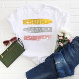 Believe Dream Shine Word Art Sublimation Transfer, white t-shirt with colorful, brush-stroke style text design and star accents.