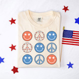 Retro Patriotic Happy Face Peace DTF Heat Transfer, colorful patriotic smiley faces and peace signs on a cream-colored T-shirt with American flag themed designs.