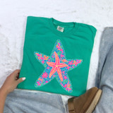 Starfish Floral DTF Heat Transfer, colorful starfish with pink and purple flowers design on a green T-shirt.