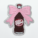 Dr. Pepper Bottle Embroidered HAT/POCKET Patch, decorative patch featuring a detailed embroidered image of a Dr. Pepper bottle with a pink bow and silver glitter border.