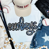 Cowboys Sequin Patch, sparkling multicolored sequin patch spelling 'cowboys' on a white t-shirt.