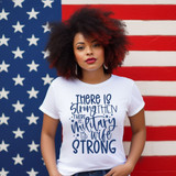 There Is Strong Then There Is Military Wife Strong Blue DTF Heat Transfer, front view of a woman wearing a white T-shirt with text design, standing against an American flag background.
