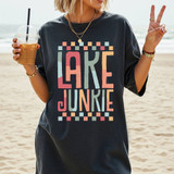 Lake Junkie Boho DTF Heat Transfer, colorful design on a black T-shirt worn by a woman at the beach.
