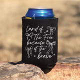 Land Of The Free Because Of The Brave Coquette Bows WHITE DTF Heat Transfer, black fabric drink koozie with white bow and star illustrations and patriotic quote.