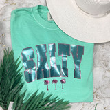 Salty SequinTransfer product, mint green t-shirt with shiny sequin lettering saying 'SALTY' and palm tree graphics, summer beach style.