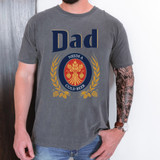 Dad Needs A Cold Beer DTF Heat Transfer, gray t-shirt with a design that says Dad needs a cold beer surrounded by wheat and hops illustrations.